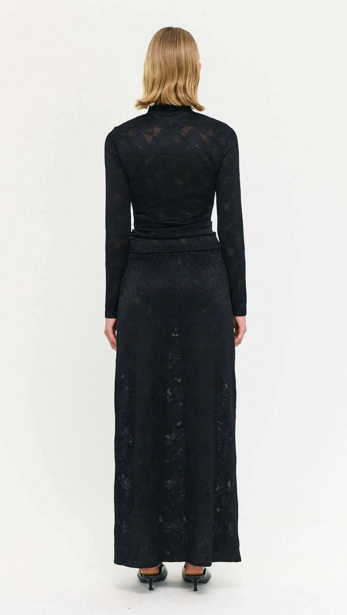 The Black Sheer Lace Long Sleeve Top offers a refined take on elevated layering.