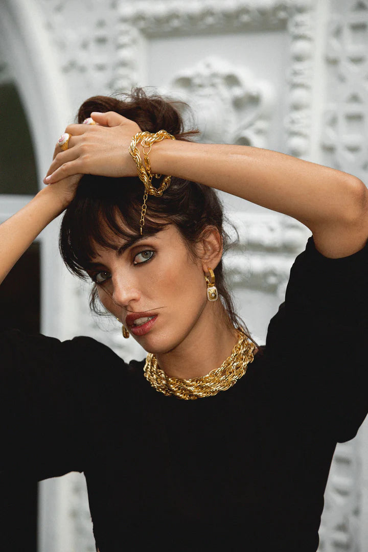 The Mara's are the epitome of classic style with a fabulous yet playful twist. They're beautiful, chic, and oh-so sassy… Crafted on a chunky fluted hoop, they feature a unique rectangle motif drop, combine with hammered gold texture, pearlescent enamel and eye-catching faceted Crystal Quartz gemstones. The Mara Earrings can be worn from day to night, with dazzling yet sophisticated flair that’s sure to turn heads. Enjoy the perfect balance of classic yet flirty with these