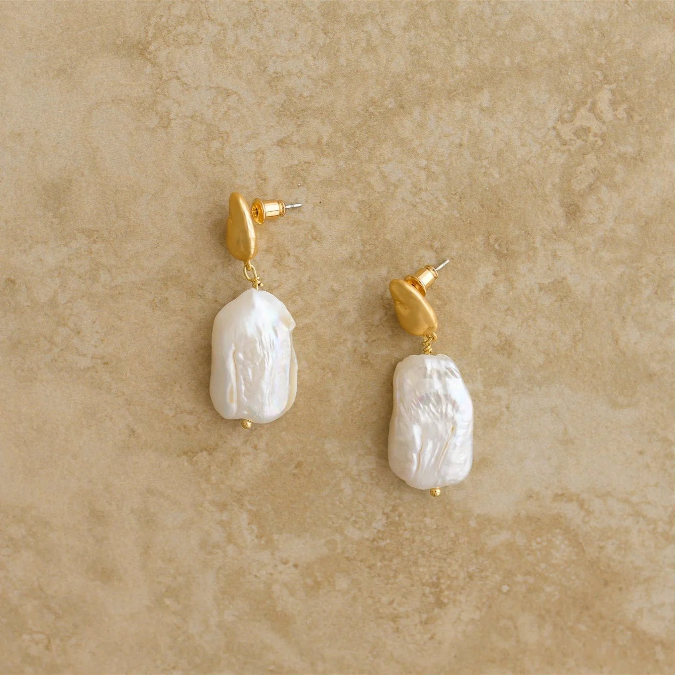 Our ALESSIA earrings are a must have masterpiece, showcasing nature's purest pearls. The perfect pair of earrings for a boho bride!
S925 Gold Plated Sterling Silver
Baroque Pearl/Drop Earrings
Lead,Nickel & Tarnish Free
Hypoallergenic
Varies between 3-4cm