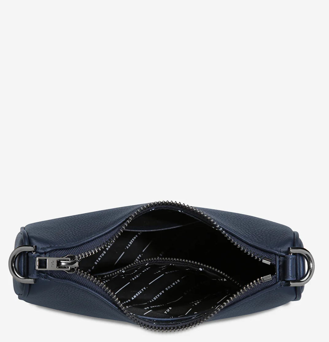 Look Both Ways Bag - Midnight Blue - Status Anxiety
The 'Look Both Ways' bag will keep people guessing with her dual personality straps. Use the shorter shoulder strap for a dressier on-the-go look or go the longer web strap option to give off a more casual 'I don't have plans today' vibe.
Soft shrunken pebble leather
Internal zipper pocket, and card slots
Dual straps (short leather strap & thin webbed strap)
Custom Status Anxiety lining
Comes in a Status Anxiety branded drawstring bag