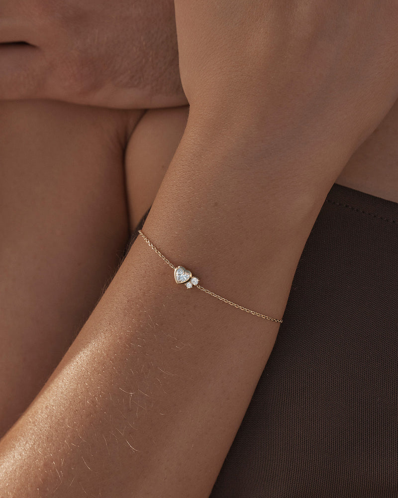 By Charlotte - The Dream Lover Heart Bracelet speaks to the unspoken connections and the in-between moments of utmost intimacy. The delicate heart cluster design encapsulates the dreamy moments of tender love and connections we hold closest to our hearts.
18k Gold Vermeil: 2.5 microns of 18 carat gold coating a sterling silver base.
Features heart (bezel setting) and round (claw) cut cubic zirconias.
Bracelet length: 19cm.
