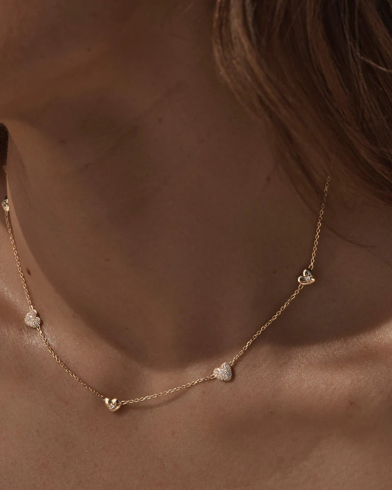 By Charlotte - The You Have My Heart Charm Choker is a joyful and sparkling proclamation of love and connection, re-imagining the heart motif into a playful charm design featuring alternating crystal encrusted pendants. Wear this design as a reminder of the love that surrounds, enriches, and strengthens you every day.
18k Gold Vermeil: 2.5 microns of 18 carat gold coating a sterling silver base.
Hearts are puffy and asymmetrical. 