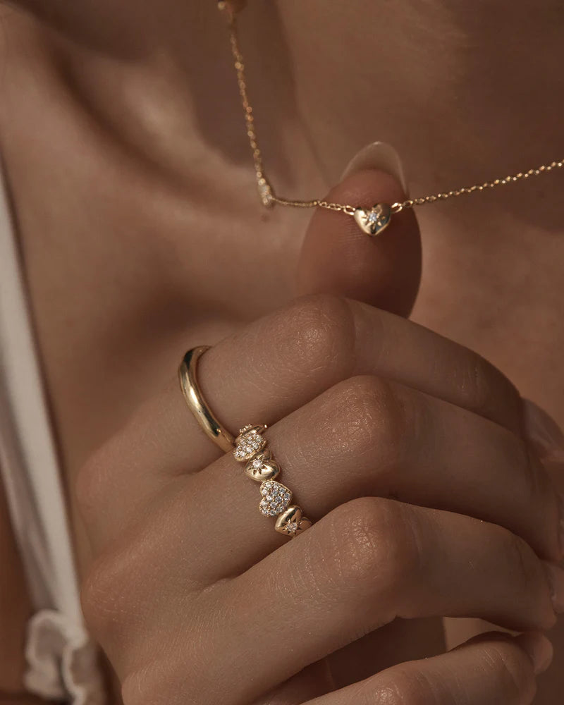 By Charlotte - The You Have My Heart Band Ring is a joyful and sparkling proclamation of love and connection, re-imagining the heart motif into a playful charm design featuring alternating crystal encrusted pendants. Wear this design as a reminder of the love that surrounds, enriches, and strengthens you every day.
18k Gold Vermeil: 2.5 microns of 18 carat gold coating a sterling silver base.
Band ring design featuring alternating hearts.
Set with cubic zirconias in claw and pavé settin