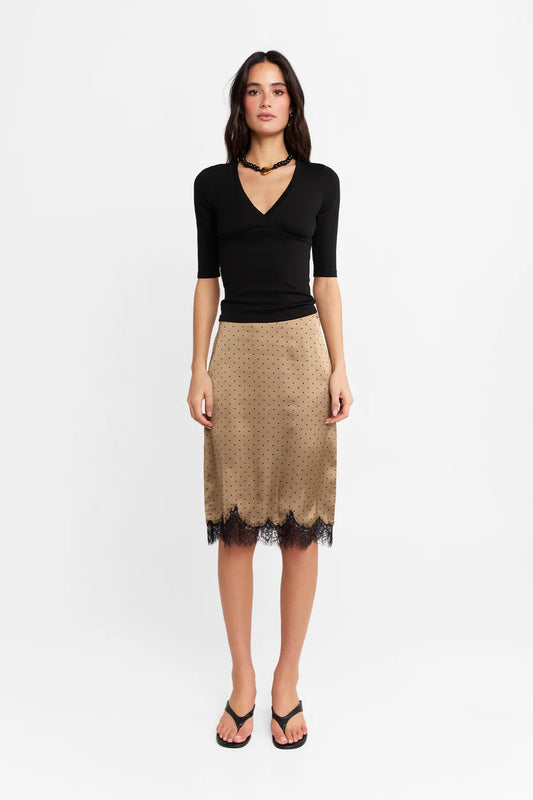 The Lucia Skirt by Madison The Label is an elegant mid rise design. This fitted midi skirt is mid rise and features a straight column silhouette. It is crafted in a polka dot printed satin fabrication with a contrast lace panel at hem. The hem has a scalloped edge adding a touch of uniqueness while maintaining it's feminine look with the lace detail. Pair with the Samira Top for the complete look.

Hope is wearing a size XS (AU6). She is 180cm (5'11), has a 58cm bust, 58cm waist, and 89cm hips.