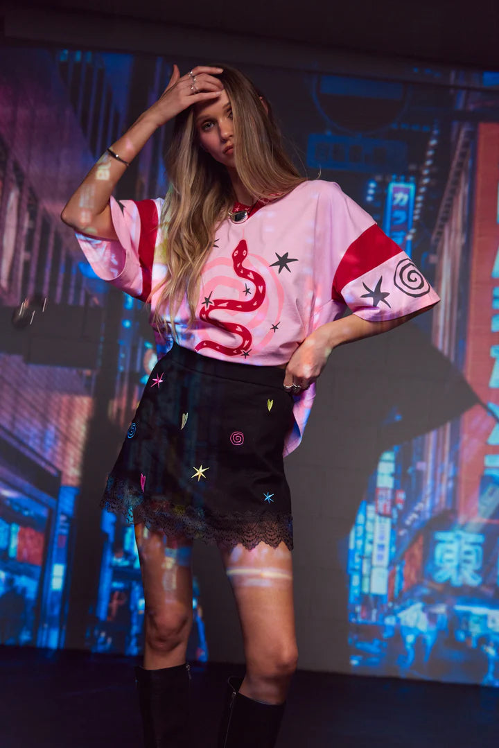 Bring a touch of magic to your wardrobe with our Lucky Mini Skirt by Only Lovers Left, sprinkled with our signature lucky and omen symbols. Its playful embroidery and vintage-inspired lace hem make it a statement piece that’s effortlessly wearable. The A-line shape, flat front, and softly elasticated back ensure it sits comfortably at your waist while creating an easy, flattering silhouette.