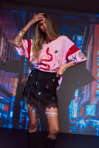 Bring a touch of magic to your wardrobe with our Lucky Mini Skirt by Only Lovers Left, sprinkled with our signature lucky and omen symbols. Its playful embroidery and vintage-inspired lace hem make it a statement piece that’s effortlessly wearable. The A-line shape, flat front, and softly elasticated back ensure it sits comfortably at your waist while creating an easy, flattering silhouette.