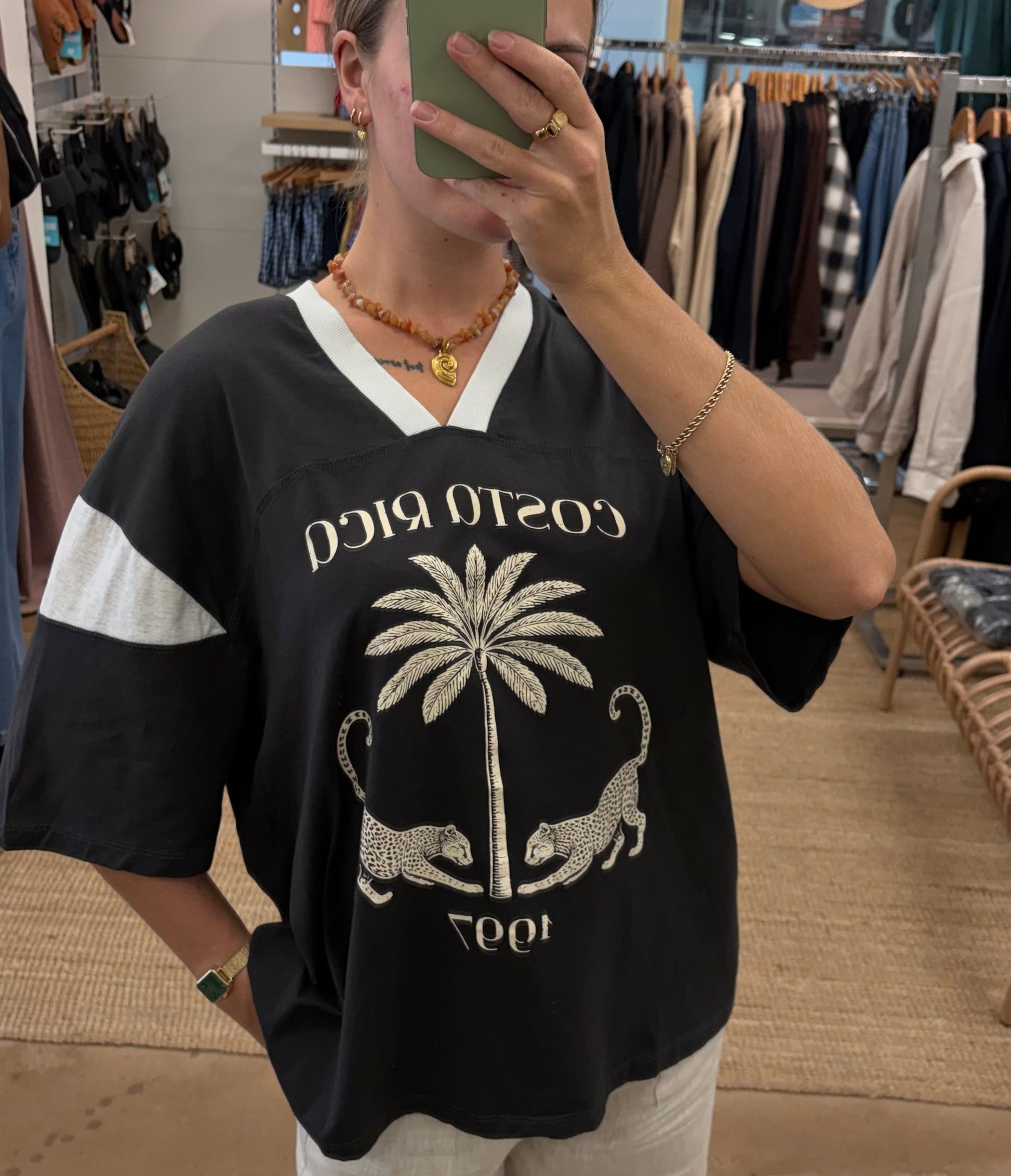 Costa Rica Tee - PaperHeart 

The Costa Rica Tee features a structured, oversized fit with a V-neckline, providing comfort and breathability. Its black-grey colorway highlights a detailed graphic print of a leopard and palm tree, reflecting Costa Rica's natural environment. The design balances style with casual versatility.