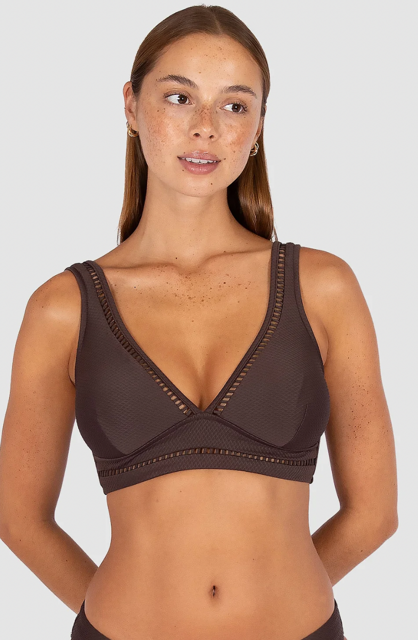 Baku Swimwear 

Crafted in Rococco — Baku's exclusive Spanish textural fabrication that's buttery soft yet beautifully structured — this longline bra top is one of the collection's most elegant styles, with ladder lace detailing at the neck and under the bust.

Best suited for D to DD cup sizes
V neckline with ladder lace detailing at the neck and under the bust for a refined, feminine finish
Side boning for a lifted, sculpted silhouette
Soft removable cups for contouring and shaping