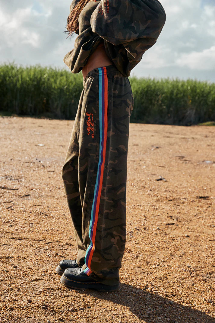 YOU HAVE ALWAYS BEEN ENOUGH!


Stand out in our 100% cotton camo trackpants.
A relaxed fit barrel leg pant with a drawstring waist, two side pockets and woven taped down both leg. These pants gonna get you through the colder months in style.