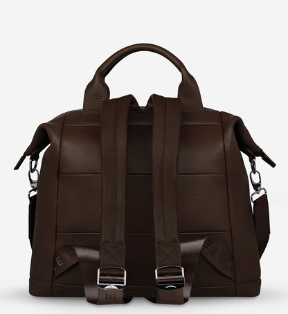 Comes In waves Cocoa - Status Anxiety 

Made to double as an oversized backpack or baby bag. The 'Comes In Waves' bag has enough space and pockets to keep everything in just the right place, and can be clipped onto the handle of a pram with our 'Up All Night' baby bag straps (sold separately).

Soft shrunken pebble leather
Front zipper pocket
Internal zipper pocket, and open pouch pockets
Internal bottle pockets
Internal key clip
Zipper close
Padded shoulder straps
Fits a 16 inch MacBook