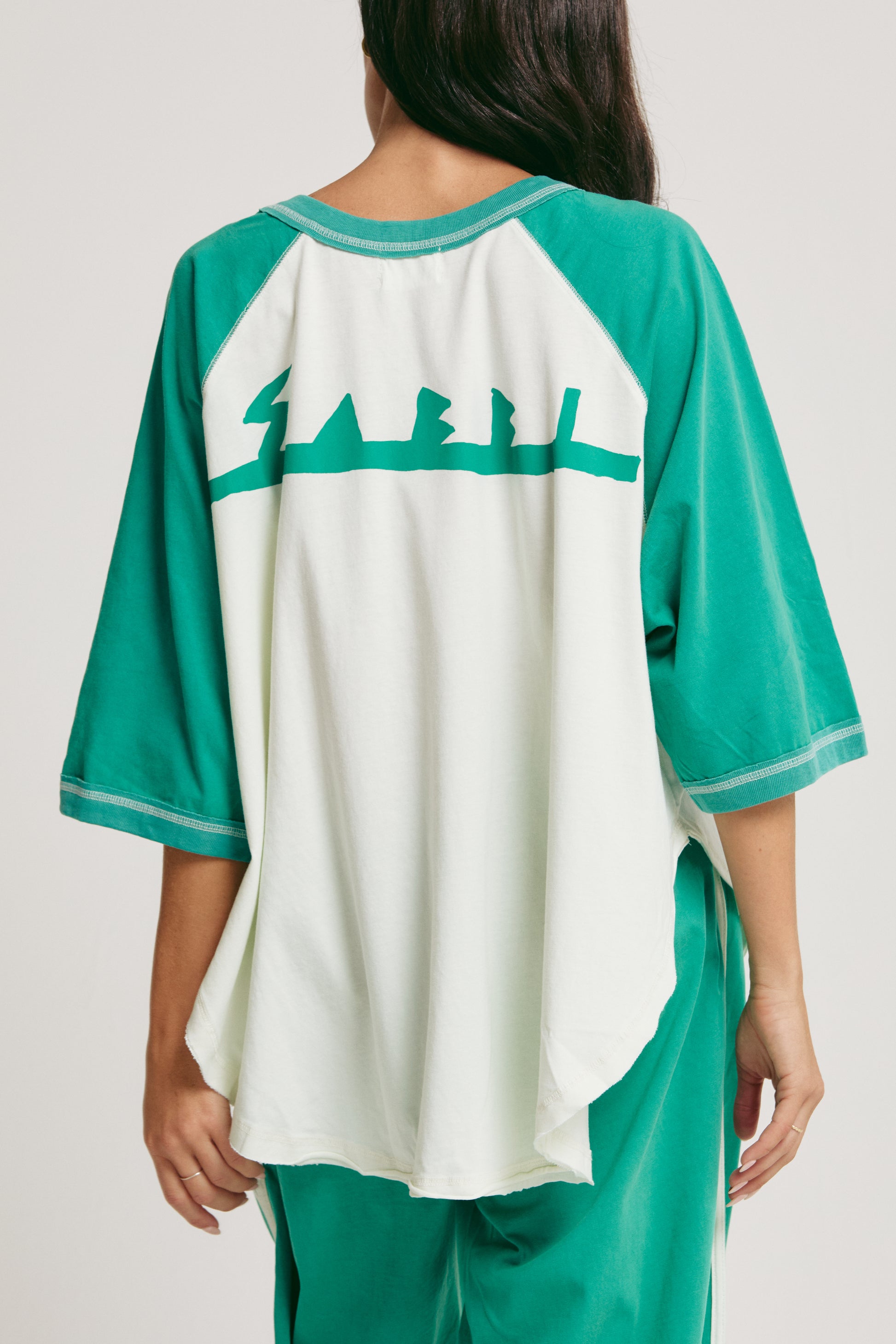 Salt in the air. No plans. Just vibes. 

Meet the Sabbi Raglan Margie Tee, your go-to for slow mornings, sunset hangs, and those “just one more” kind of nights. With a relaxed, oversized raglan fit, this tee drapes effortlessly, feeling as easy on the body as it looks on you.

Made from soft, breathable cotton, it’s lightweight enough to keep you cool but cozy enough to lounge in all day. The contrast raglan sleeves and curved hem give it that perfectly undone, throw-on-and-go energy, while the playful