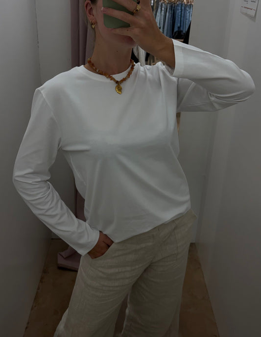 Athena Long Sleeve - White - Little Lies 

The Athena Stripe, a long-sleeved basic tee evolved from our best-selling Athens and Rhodes styles, is crafted from a soft cotton/spandex blend with a round neckline, straight hemline, and hemmed long sleeves, offering a buttery feel and perfect stretch for all-day comfort.

FEATURES:

Round neckline
Straight hemline
Hemmed long sleeve
FABRIC: 100% Cotton