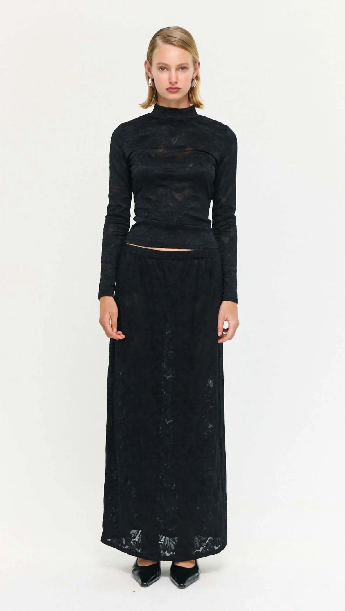 The Black Sheer Lace Long Sleeve Top offers a refined take on elevated layering.