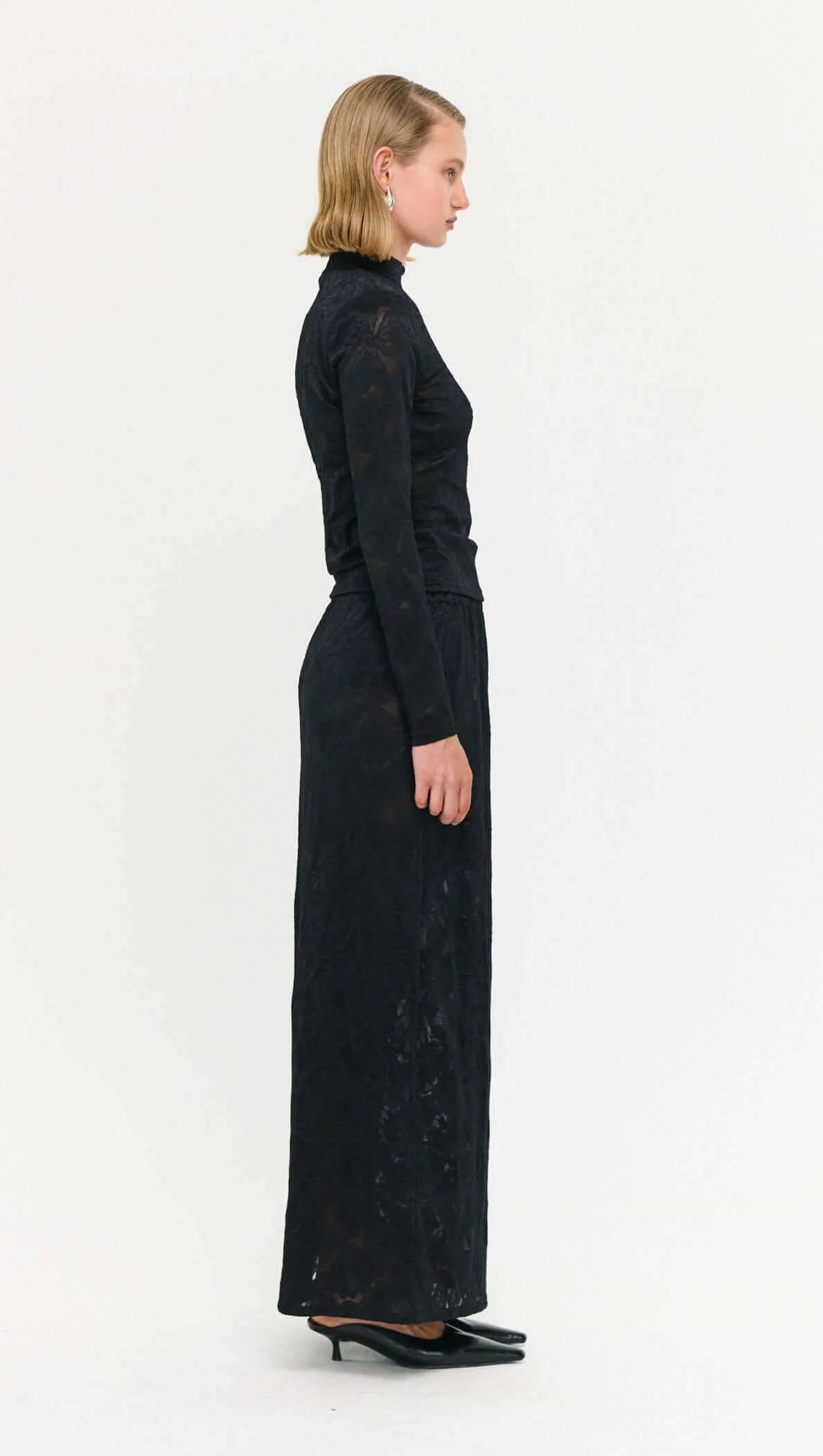 The Sheer Lace Maxi Skirt brings a modern, textural edge to occasion and everyday dressing.