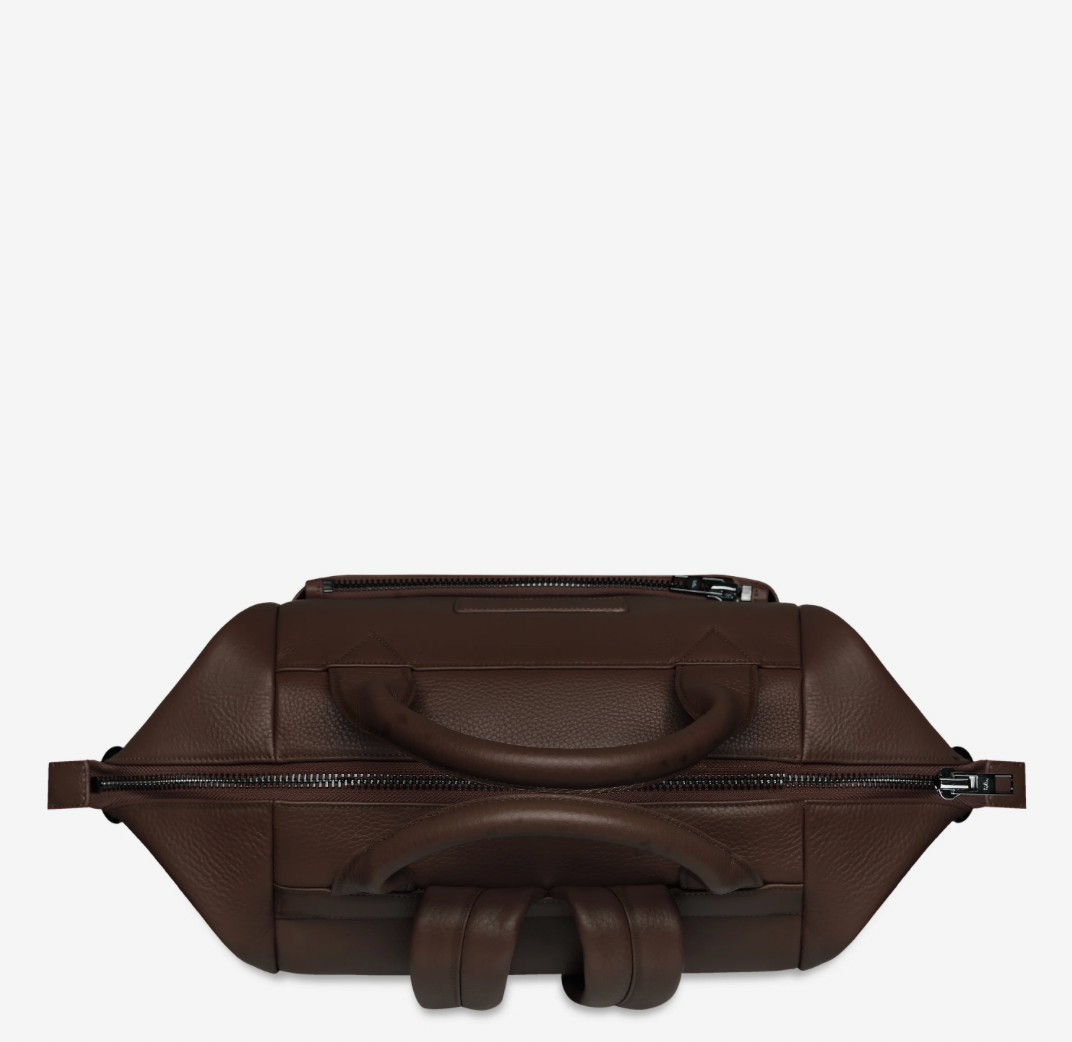 Comes In waves Cocoa - Status Anxiety 

Made to double as an oversized backpack or baby bag. The 'Comes In Waves' bag has enough space and pockets to keep everything in just the right place, and can be clipped onto the handle of a pram with our 'Up All Night' baby bag straps (sold separately).

Soft shrunken pebble leather
Front zipper pocket
Internal zipper pocket, and open pouch pockets
Internal bottle pockets
Internal key clip
Zipper close
Padded shoulder straps
Fits a 16 inch MacBook