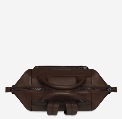 Comes In waves Cocoa - Status Anxiety 

Made to double as an oversized backpack or baby bag. The 'Comes In Waves' bag has enough space and pockets to keep everything in just the right place, and can be clipped onto the handle of a pram with our 'Up All Night' baby bag straps (sold separately).

Soft shrunken pebble leather
Front zipper pocket
Internal zipper pocket, and open pouch pockets
Internal bottle pockets
Internal key clip
Zipper close
Padded shoulder straps
Fits a 16 inch MacBook