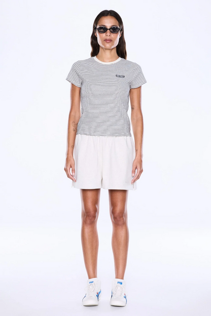 Bold Lines. Casual Rhythm.
The Penny Baby Tee from Ena Pelly  is made from soft cotton baby rib with added stretch in a fitted cropped silhouette that hugs the body with ease. Designed with cap sleeves, a crew neckline, striped detailing and a branded woven badge for an elevated everyday finish.