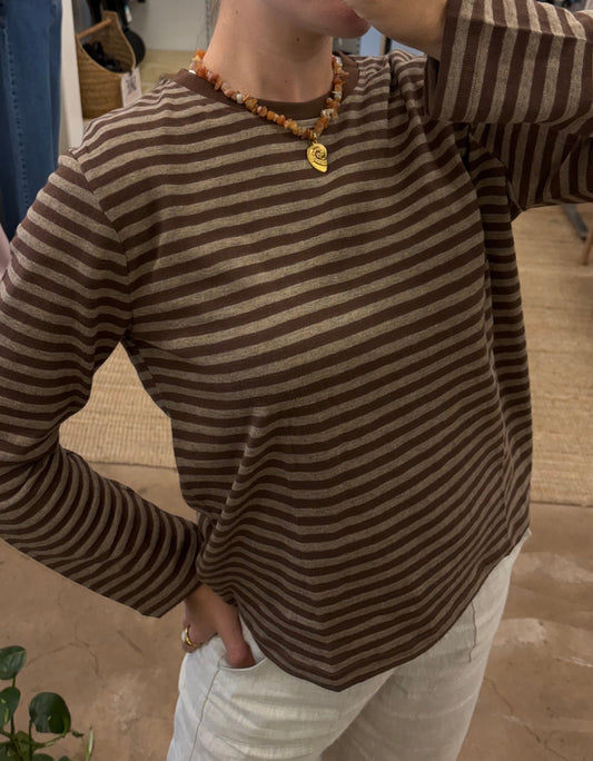 Athena Long Sleeve - Brown - Little Lies 

The Athena Stripe, a long-sleeved basic tee evolved from our best-selling Athens and Rhodes styles, is crafted from a soft cotton/spandex blend with a round neckline, straight hemline, and hemmed long sleeves, offering a buttery feel and perfect stretch for all-day comfort.

FEATURES:

Round neckline
Straight hemline
Hemmed long sleeve
FABRIC: 100% Cotton