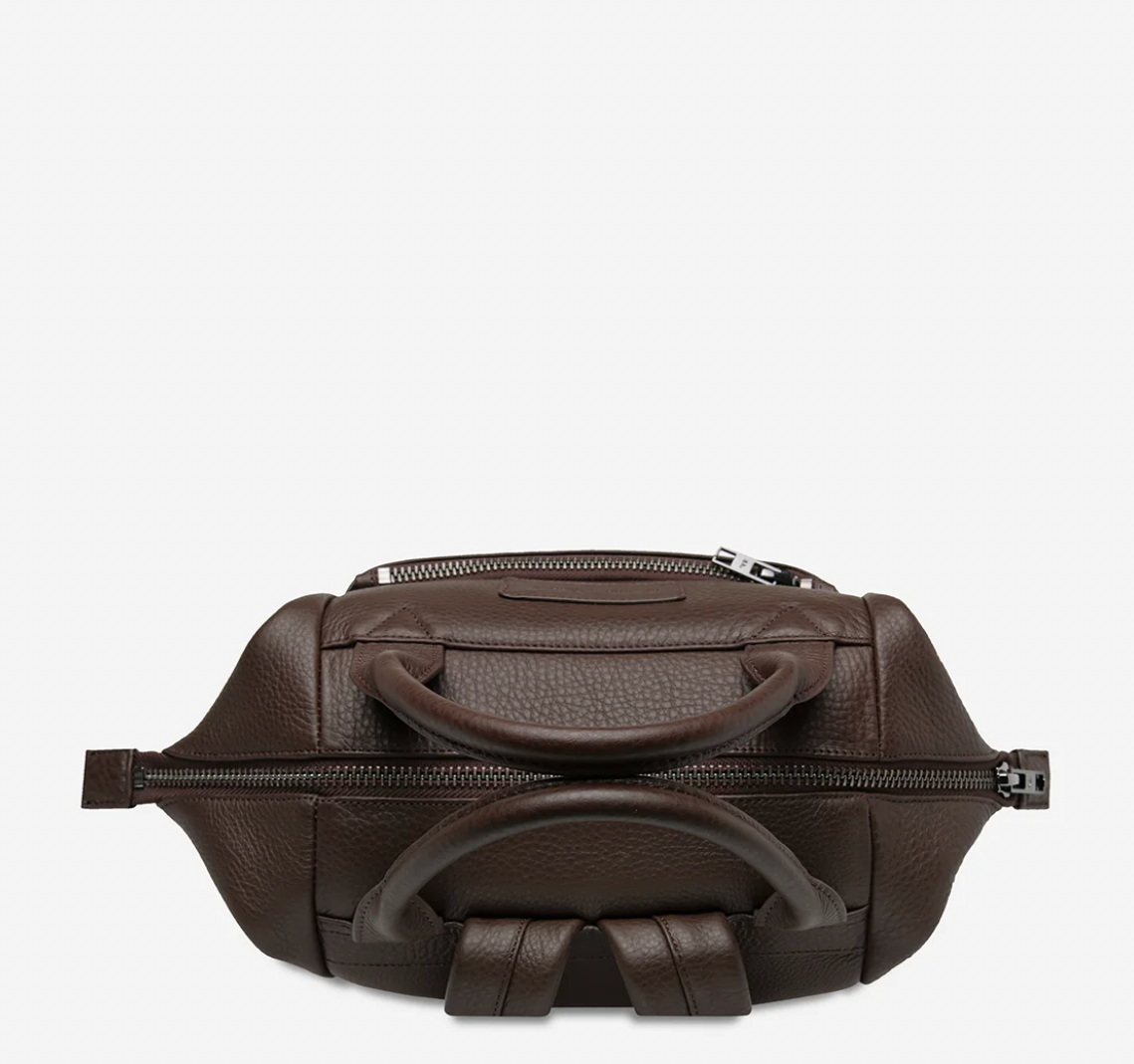 Mini waves Cocoa - Status Anxiety 

Made in response to the (very) popular request to make a smaller size version of our best selling 'Comes In Waves' bag. Mini Waves is the perfect uni or work bag with a wide opening top, space for your laptop and multiple compartments to keep everything in its place. Carry in hand with the top straps, over the body with the long webbed strap (included), or on your back with the shoulder straps. Big enough to carry everything you need, not too big to slow you down.