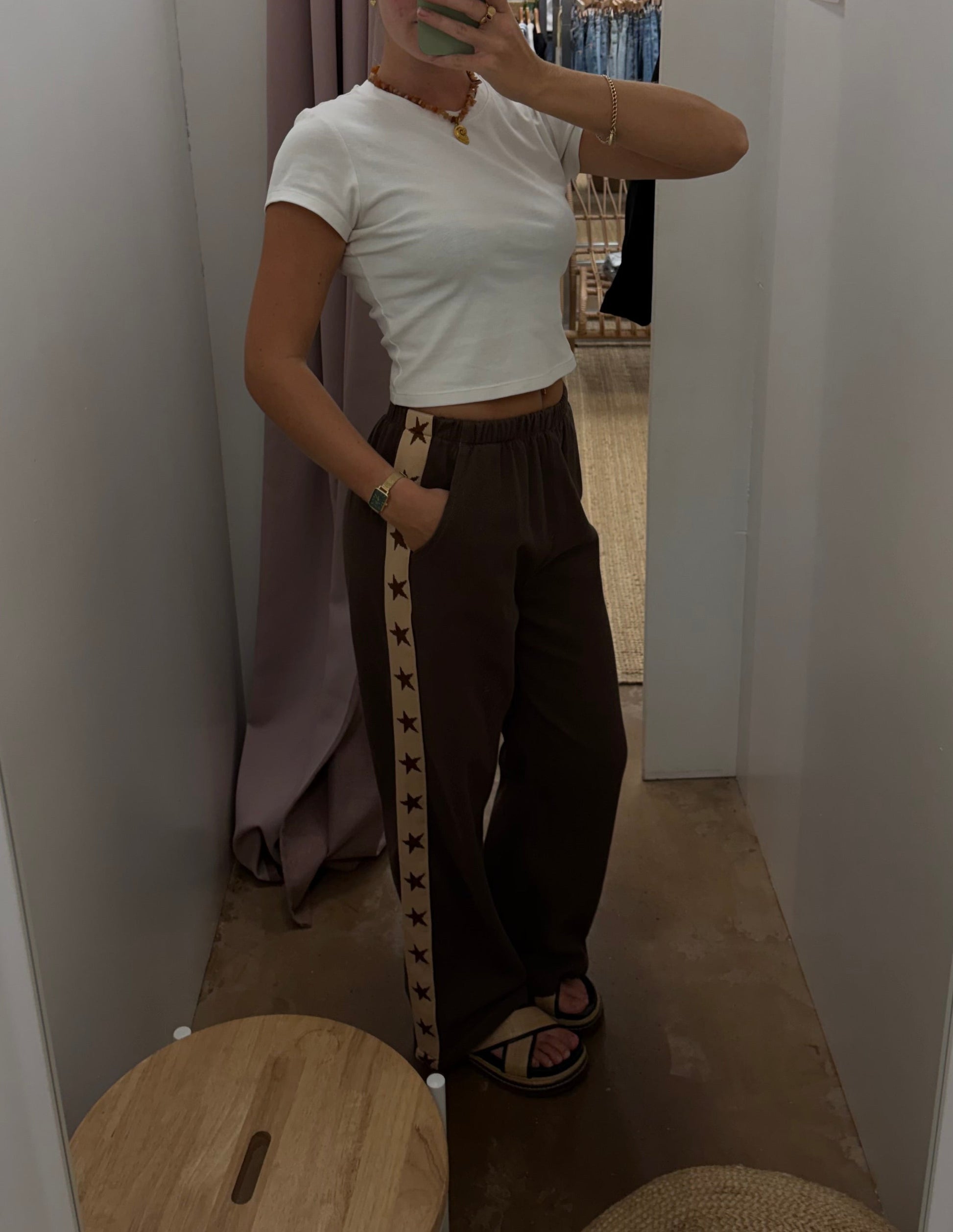 Star Racer Pants - By Frankie 

Details
Make a statement with the Star Racer Pants in chocolate brown and cream stripe. The high-waisted silhouette features an elasticated waistband and front tie detail for a flattering fit. Practical side pockets and a straight leg cut complete the look.

Product Details:

High waisted
Elasticated waist band
Front tie detail
Side pockets
Straight leg fit
Race stripe detail on side seams