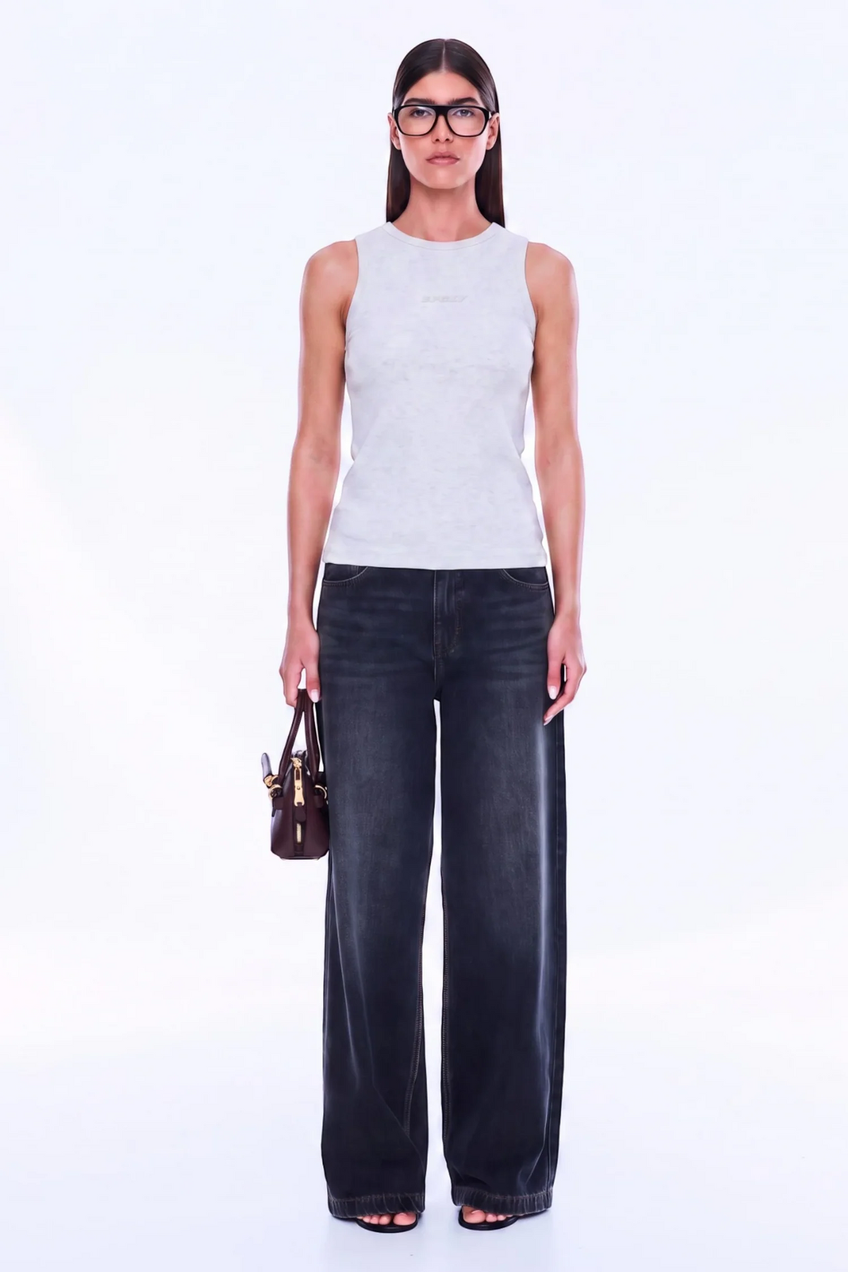 Soft Texture. Confident Mood. The Celine Tank is crafted in cotton with a fitted silhouette, using soft rib fabrication to create a streamlined oat marle base. Finished with a classic crew neckline and exclusive in-house stack print branding, tonal Ena Pelly detailing keeps the look understated and refined for an effortless everyday layer.