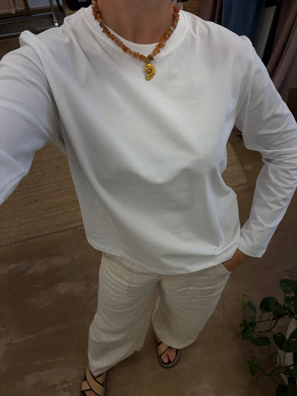 Athena Long Sleeve - White - Little Lies 

The Athena Stripe, a long-sleeved basic tee evolved from our best-selling Athens and Rhodes styles, is crafted from a soft cotton/spandex blend with a round neckline, straight hemline, and hemmed long sleeves, offering a buttery feel and perfect stretch for all-day comfort.

FEATURES:

Round neckline
Straight hemline
Hemmed long sleeve
FABRIC: 100% Cotton