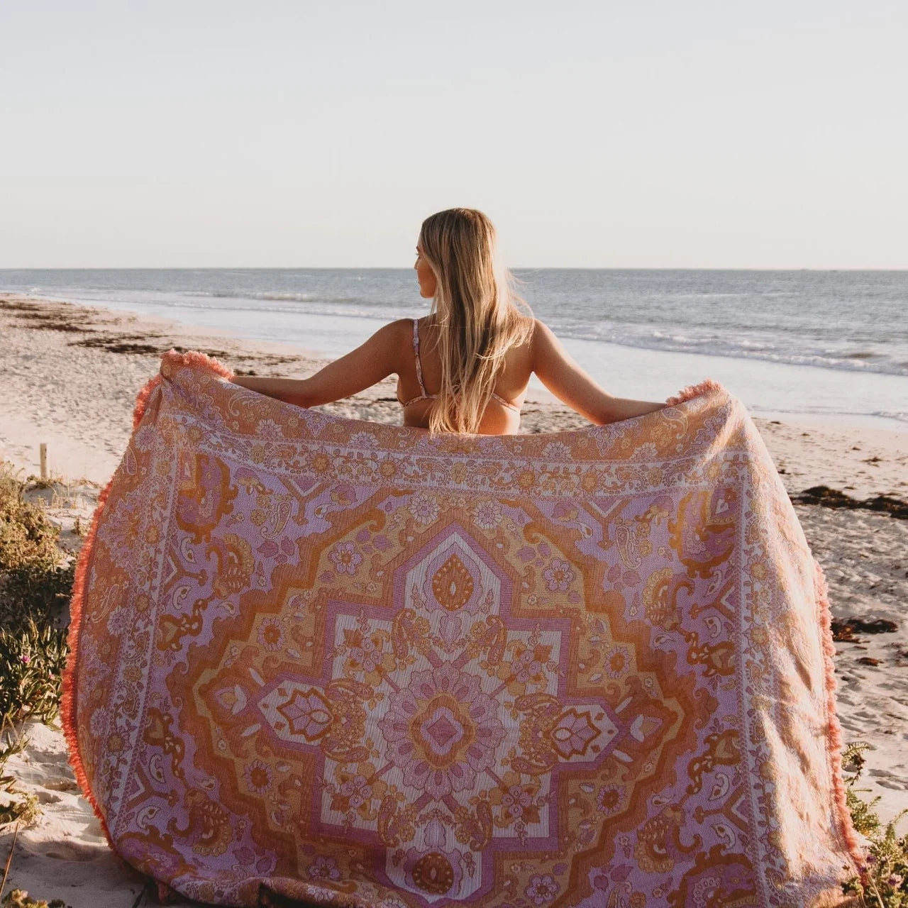 Sundown Picnic Rug - Isla
Created with only the dreamiest sunset hues, Sundown is reminiscent of all of your favourite holiday moments. Endless beach days, the smell of coconut sunscreen, balmy afternoons, ocean swims and sunset picnics with the girls sipping on your favourite fruit cocktail. Created to give you good summer vibes with hues of coral, pinks, yellow, orange and cream.

- Made with 100% cotton 

- One colour tassel trim around the rug

- Extra large picnic rug - approx 190 x 160cm 