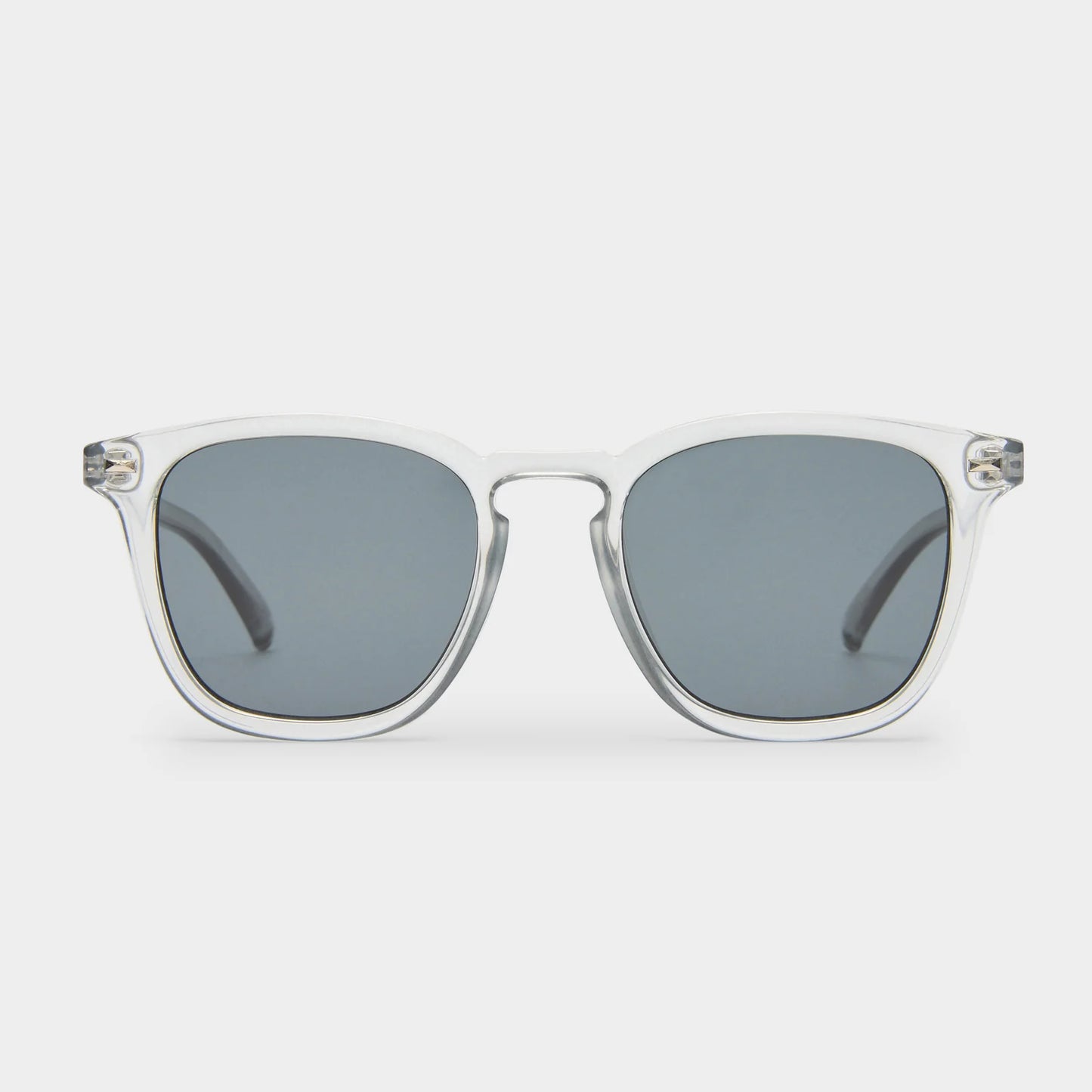 NO BIGGIE is a modern take on a fifties rectangular shape, offering the sharpest look of the season. Featuring classic rivet detailing, it combines bold style with timeless appeal.

• Finished in a crystal grey frame with dark lenses.
• Made using BPA free polymer plastic which is lightweight, durable and impact resistant.
• Fitted with shatterproof and scratch resistant polycarbonate lenses
