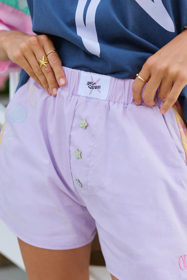 Playful, Breezy, and Ready for Summer

Step into sun-soaked style with the Shell Club Boxer Shorts from Only Lovers Left. Crafted from 100% washed cotton, these shorts are lightweight, breathable, and perfect for all your warm-weather adventures. With relaxed mid-thigh length and a soft elastic waistband, they’re effortlessly comfortable while staying stylishly playful.