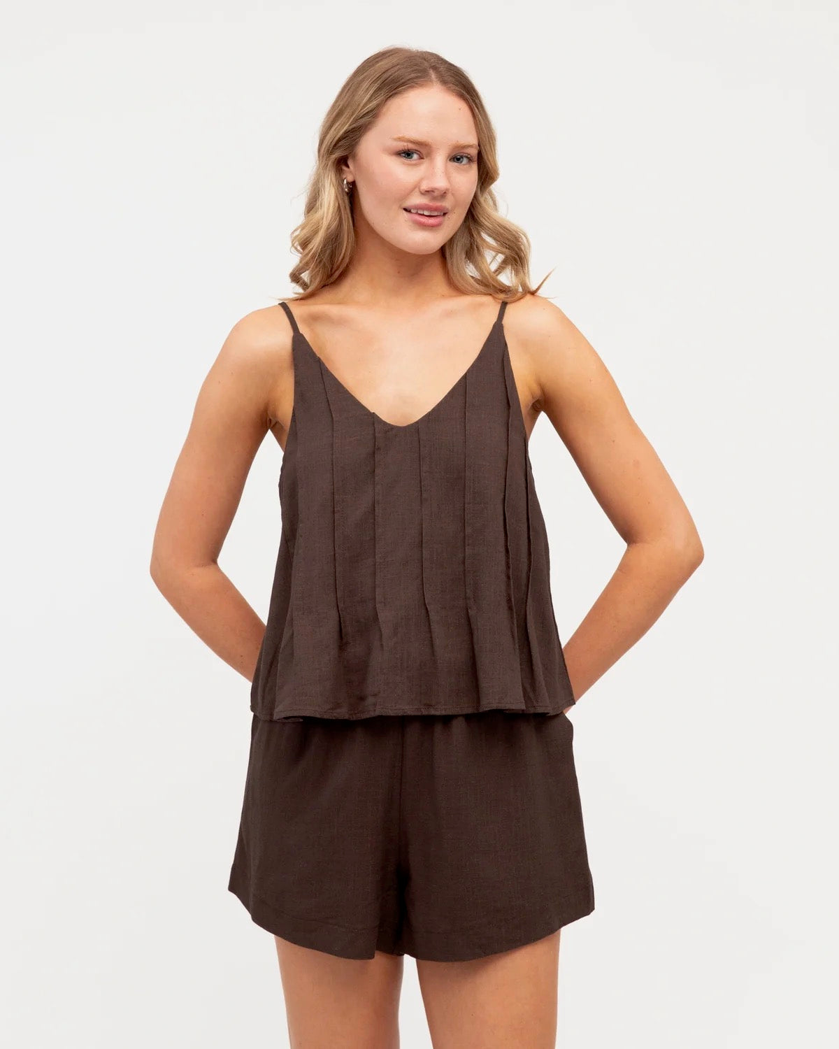 A gorgeous brown top and shorts set made for everyday comfort and effortless style. Soft, easy to wear and perfect for everyday adventures, this versatile set can be worn together or styled separately for endless outfit options.

V neckline
Adjustable thin straps
Pleat detail
Front tuck design
Mid-rise waist
Elastic waist with tie
Side pockets
Mini length
Relaxed fit
Lined
Fabric: cotton polyetser