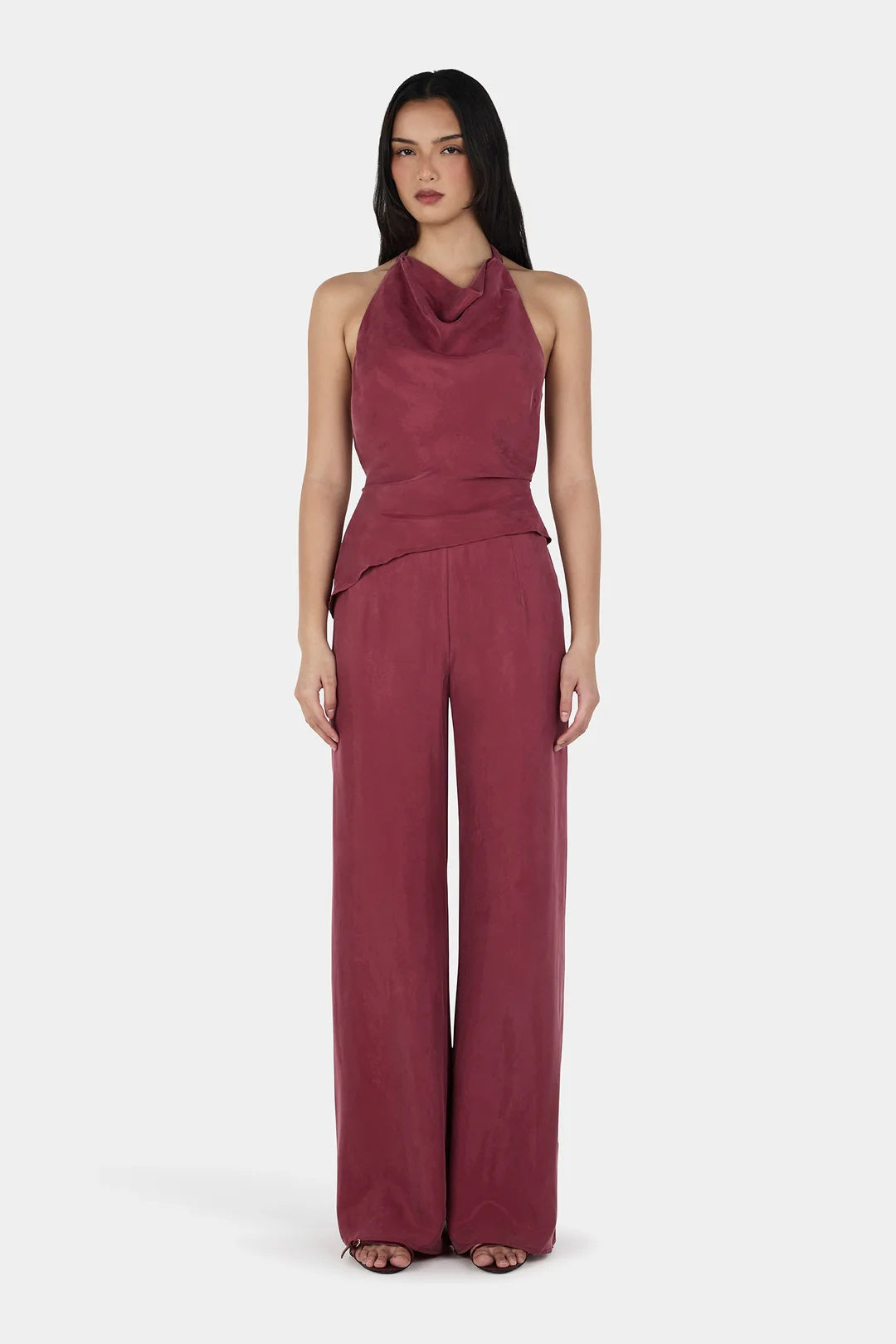 Tailored ease meets everyday elegance.

The Aeris Pant by Ownley is a mid to high-rise style crafted from soft cupro fabric, designed to drape effortlessly over the body. It features a wide-leg silhouette for a relaxed yet elevated look, complemented by a gently elasticated waistband for added comfort. A discreet side-seam invisible zipper keeps the finish clean and streamlined. Pair it with the Iris Halter for a refined matching set.
