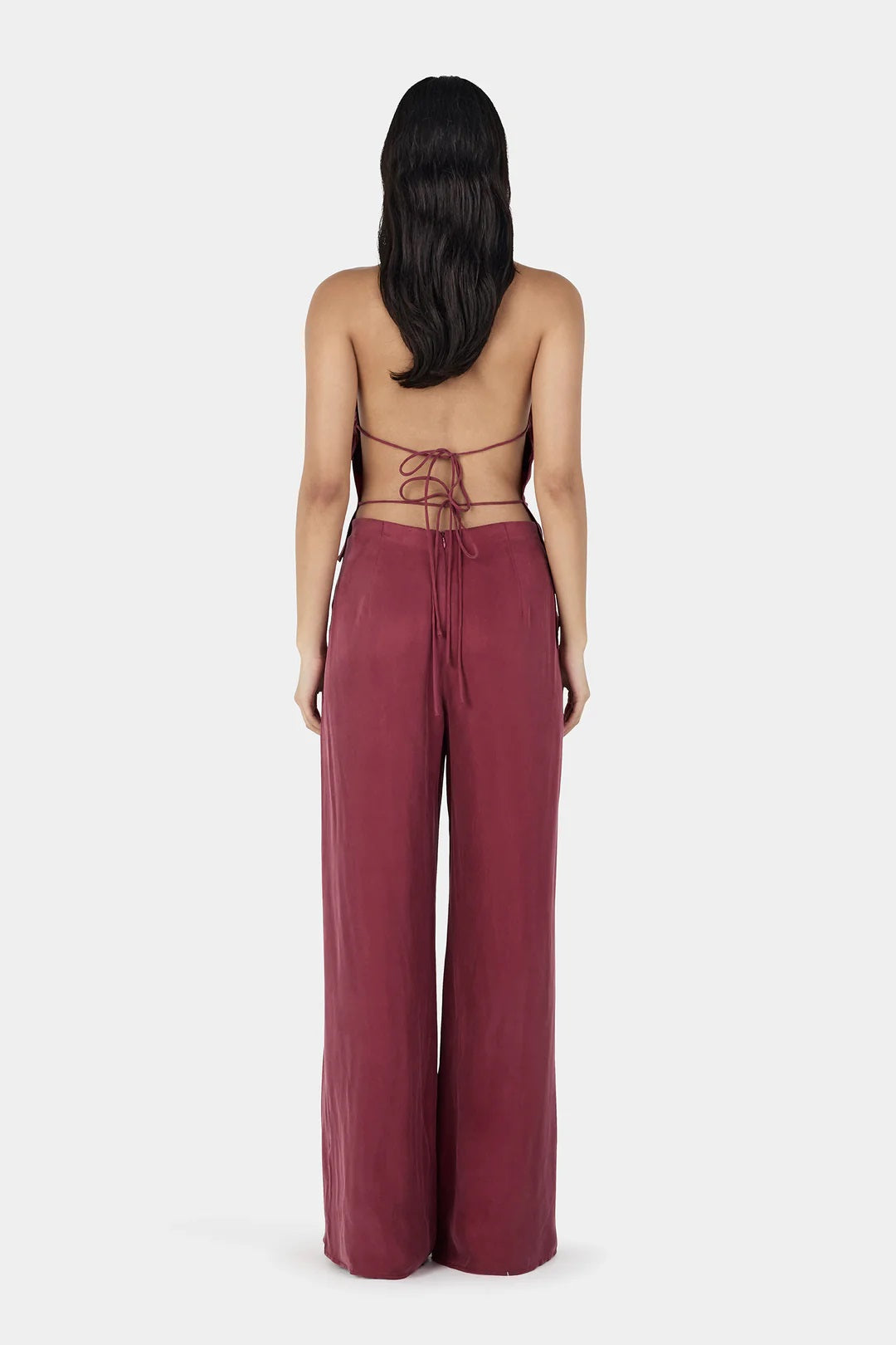 Tailored ease meets everyday elegance.

The Aeris Pant by Ownley is a mid to high-rise style crafted from soft cupro fabric, designed to drape effortlessly over the body. It features a wide-leg silhouette for a relaxed yet elevated look, complemented by a gently elasticated waistband for added comfort. A discreet side-seam invisible zipper keeps the finish clean and streamlined. Pair it with the Iris Halter for a refined matching set.