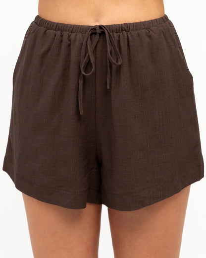 A gorgeous brown top and shorts set made for everyday comfort and effortless style. Soft, easy to wear and perfect for everyday adventures, this versatile set can be worn together or styled separately for endless outfit options.

V neckline
Adjustable thin straps
Pleat detail
Front tuck design
Mid-rise waist
Elastic waist with tie
Side pockets
Mini length
Relaxed fit
Lined
Fabric: cotton polyetser