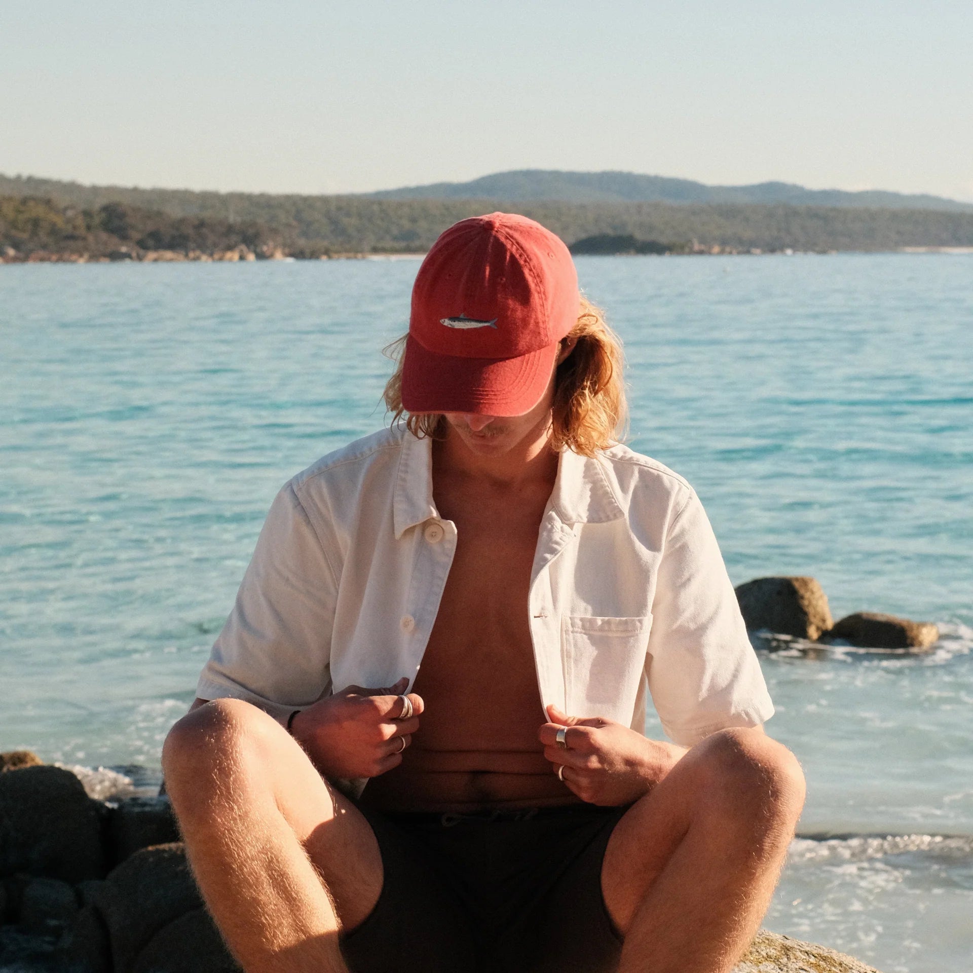 The Sardine Lid by Pallion PT  (Sardinops sagax) is a premium cotton dad cap in a punchy, tomato sauce red. Soft but structured. Relaxed but refined. Embroidered with a hand-drawn sardine, because small fish can still make a splash.