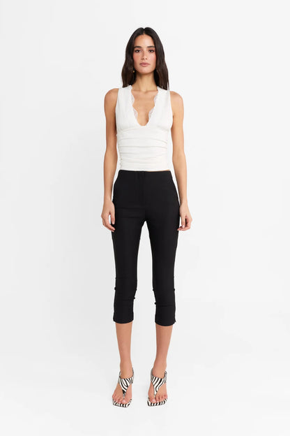 Introducing the Camille Top by Madison The Label, an elegant twist to an everyday basic. This fitted top features a deep V neckline, contrast lace trim through neckline, and under bust seam detail with soft gathers. It is fully lined with a fitted silhouette, gathered waist detail, and it's crafted in a soft stretch fabrication. Pair with the Paloma Pants to complete the look.

Hope is wearing a size extra small. She is 180cm (5'11) tall, has an 76cm bust, 58cm waist and 89cm hips.
