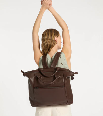 Comes In waves Cocoa - Status Anxiety 

Made to double as an oversized backpack or baby bag. The 'Comes In Waves' bag has enough space and pockets to keep everything in just the right place, and can be clipped onto the handle of a pram with our 'Up All Night' baby bag straps (sold separately).

Soft shrunken pebble leather
Front zipper pocket
Internal zipper pocket, and open pouch pockets
Internal bottle pockets
Internal key clip
Zipper close
Padded shoulder straps
Fits a 16 inch MacBook