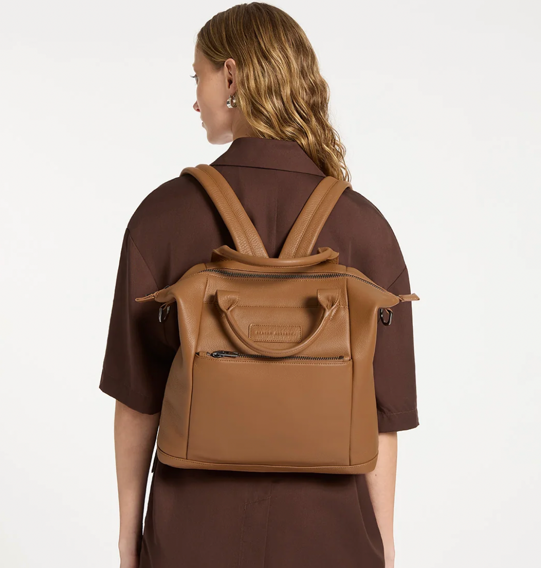 Mini waves Camel - Status Anxiety 

Made in response to the (very) popular request to make a smaller size version of our best selling 'Comes In Waves' bag. Mini Waves is the perfect uni or work bag with a wide opening top, space for your laptop and multiple compartments to keep everything in its place. Carry in hand with the top straps, over the body with the long webbed strap (included), or on your back with the shoulder straps. Big enough to carry everything you need, not too big to slow you down.