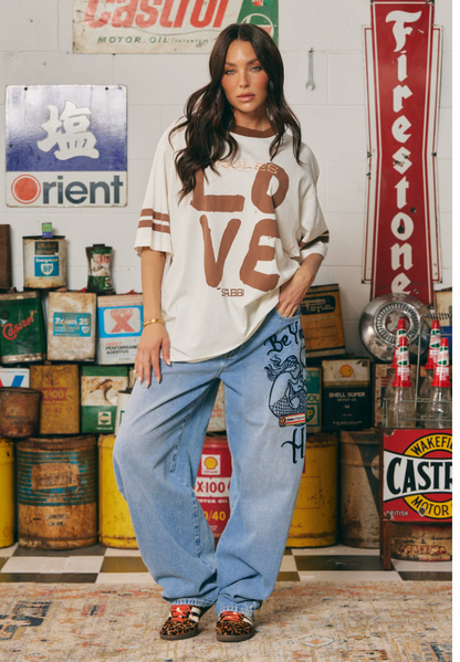 THE VERY OVERSIZED LOVE REVOLUTION TEE - OFF WHITE SABBI

IT'S A SABBI LOVE REVOLUTION!

The Very Oversized Love Revolution Tee is for rule-breakers, fun lovers and peeps who like their tees oversized and wear their hearts on their sleeves.

Designed in a very oversized, relaxed silhouette, this tee features a bold, hand-painted LOVE graphic front and REVOLUTION print on the back. With a contrast neckline and cool double stripes around the sleeve this tee is perfect for throwing on post-swim.