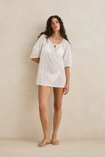 Meet your “throw it on and instantly feel like you’re on holiday” kind of dress.

The Rhythm Lucie Mini Dress is an ethereal overswim essential made for sun-soaked days, salty air, and slow coastal living. Crafted from sheer broderie fabric, it brings that light, airy feel Rhythm does so well. Effortless, feminine, and made for easy layering.