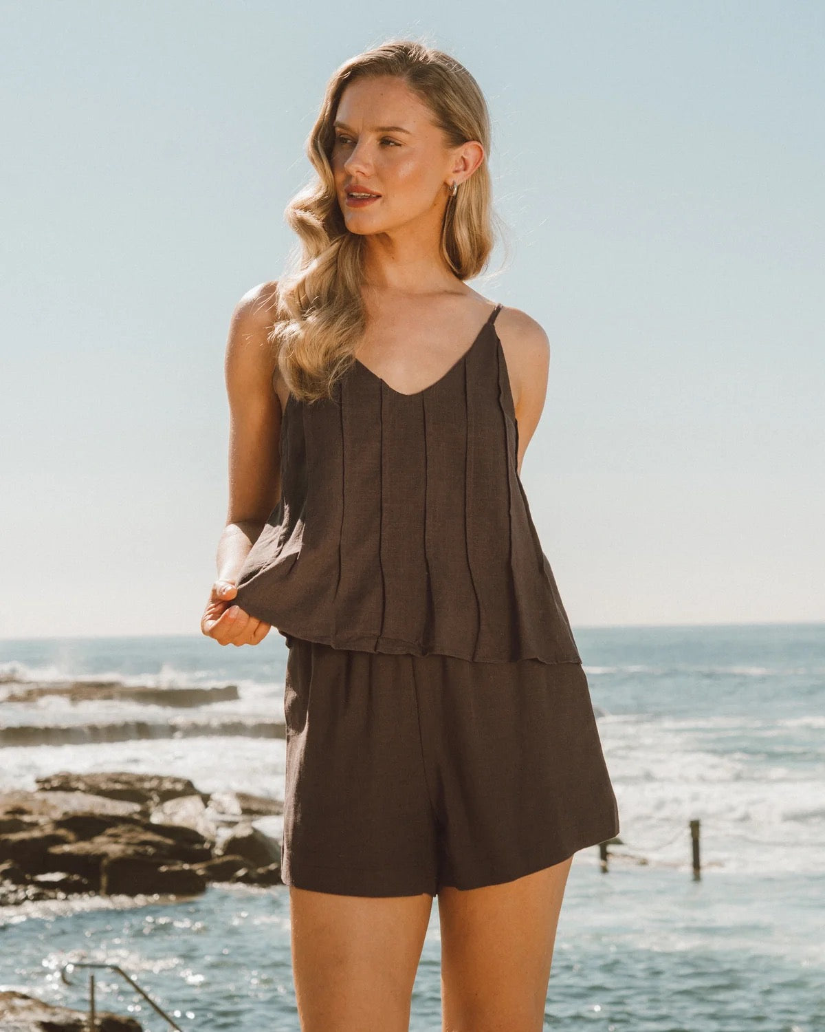 A gorgeous brown top and shorts set made for everyday comfort and effortless style. Soft, easy to wear and perfect for everyday adventures, this versatile set can be worn together or styled separately for endless outfit options.

V neckline
Adjustable thin straps
Pleat detail
Front tuck design
Mid-rise waist
Elastic waist with tie
Side pockets
Mini length
Relaxed fit
Lined
Fabric: cotton polyetser
