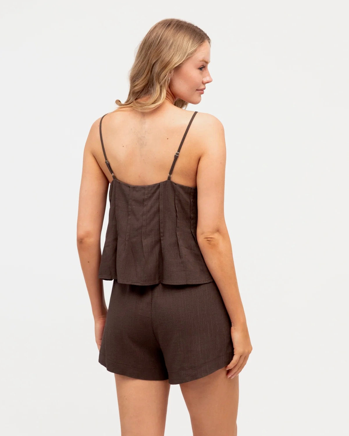 A gorgeous brown top and shorts set made for everyday comfort and effortless style. Soft, easy to wear and perfect for everyday adventures, this versatile set can be worn together or styled separately for endless outfit options.

V neckline
Adjustable thin straps
Pleat detail
Front tuck design
Mid-rise waist
Elastic waist with tie
Side pockets
Mini length
Relaxed fit
Lined
Fabric: cotton polyetser