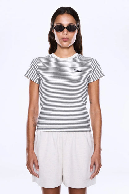 Bold Lines. Casual Rhythm.
The Penny Baby Tee from Ena Pelly is made from soft cotton baby rib with added stretch in a fitted cropped silhouette that hugs the body with ease. Designed with cap sleeves, a crew neckline, striped detailing and a branded woven badge for an elevated everyday finish.