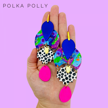 GODDESS ASTERIA 🌟

Release your inner GODDESS!

“ASTERIA was the Titan goddess of falling stars and perhaps of nighttime divinations such as oneiromancy (by dreams) and astrology (by stars). ”

BRIGHT, funky and totally unique handcrafted statement earrings. Each component is individually and lovingly handmade here at Polka Polly HQ.

Featuring hand painted leather beads mixed with a deep luxurious metallic purple Australian leather and vibrant hot pink suede with gold accents.

Set on gold toned stainless