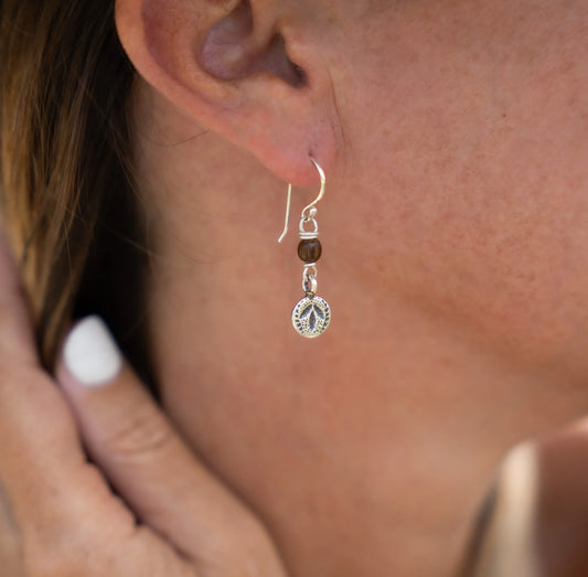 Experience the allure of the tropics with our Tropical Leaf Drops. These exquisite earrings are a harmonious blend of nature's finest elements. Crafted with precision, they feature a handcrafted and hand-stamped hilltribe silver leaf charm, symbolising growth and vitality. The tumbled wooden bead adds an earthy touch, reminiscent of the forest's tranquility. 