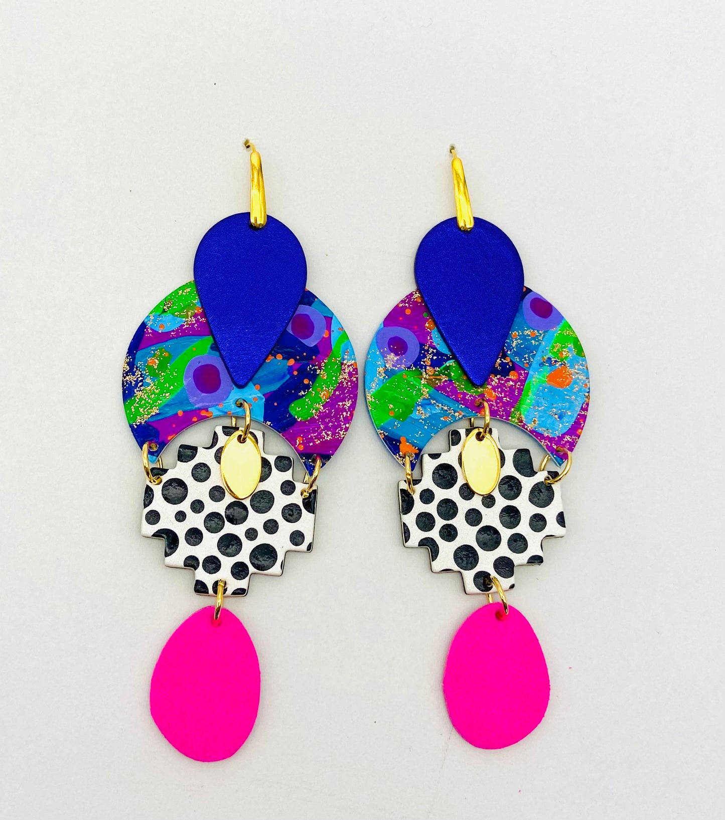GODDESS ASTERIA 🌟

Release your inner GODDESS!

“ASTERIA was the Titan goddess of falling stars and perhaps of nighttime divinations such as oneiromancy (by dreams) and astrology (by stars). ”

BRIGHT, funky and totally unique handcrafted statement earrings. Each component is individually and lovingly handmade here at Polka Polly HQ.

Featuring hand painted leather beads mixed with a deep luxurious metallic purple Australian leather and vibrant hot pink suede with gold accents.

Set on gold toned stainless