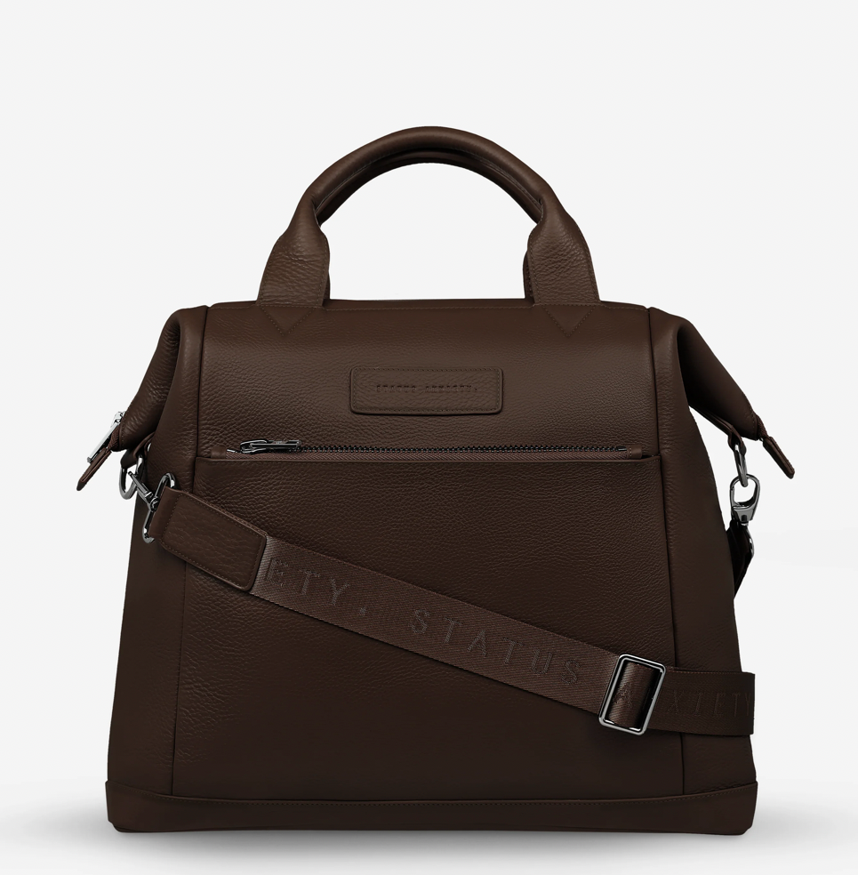 Comes In waves Cocoa - Status Anxiety 

Made to double as an oversized backpack or baby bag. The 'Comes In Waves' bag has enough space and pockets to keep everything in just the right place, and can be clipped onto the handle of a pram with our 'Up All Night' baby bag straps (sold separately).

Soft shrunken pebble leather
Front zipper pocket
Internal zipper pocket, and open pouch pockets
Internal bottle pockets
Internal key clip
Zipper close
Padded shoulder straps
Fits a 16 inch MacBook
