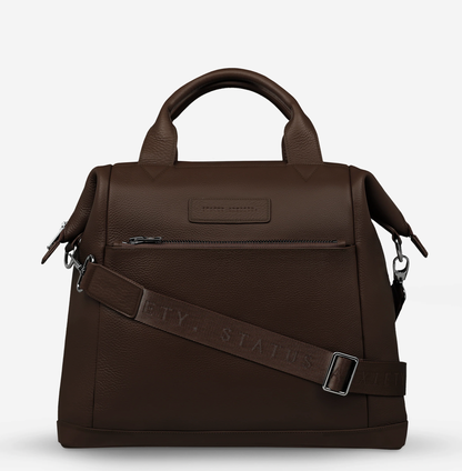Comes In waves Cocoa - Status Anxiety 

Made to double as an oversized backpack or baby bag. The 'Comes In Waves' bag has enough space and pockets to keep everything in just the right place, and can be clipped onto the handle of a pram with our 'Up All Night' baby bag straps (sold separately).

Soft shrunken pebble leather
Front zipper pocket
Internal zipper pocket, and open pouch pockets
Internal bottle pockets
Internal key clip
Zipper close
Padded shoulder straps
Fits a 16 inch MacBook