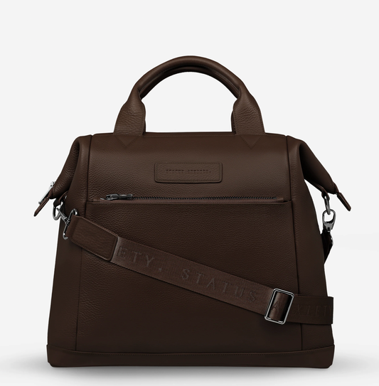 Comes In waves Cocoa - Status Anxiety 

Made to double as an oversized backpack or baby bag. The 'Comes In Waves' bag has enough space and pockets to keep everything in just the right place, and can be clipped onto the handle of a pram with our 'Up All Night' baby bag straps (sold separately).

Soft shrunken pebble leather
Front zipper pocket
Internal zipper pocket, and open pouch pockets
Internal bottle pockets
Internal key clip
Zipper close
Padded shoulder straps
Fits a 16 inch MacBook