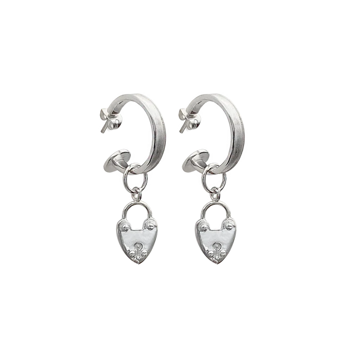 Our beloved Heart Mini Hoops, now in silver, are a perfect addition to any outfit. Whether worn with our&nbsp;gorgeous heart locket charms or solo, yes the charms are removable! These mini&nbsp;silver hoops are&nbsp;such a cute &amp; eye-catching accessory.&nbsp;Maybe you're running errands, attending a special event, or exercising, these&nbsp;small but mighty earrings are a perfect complement to your look. They're your go-to everyday earring that are never boring.&nbsp;