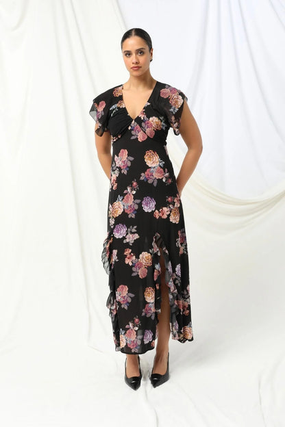 Introducing the Marilyn Maxi Dress by KACHEL - a total showstopper with a fun, flirty twist.
With a deep V-neckline, soft ruffled sleeves, and a ruffled split, this dress is all about movement, style, and feel-good vibes. Splashed in colours and a florals, it strikes the perfect balance between elegance and fun. Whether you're heading to a summer party, a garden wedding, or just want to feel amazing, this beauty is guaranteed to turn heads and brighten your day.

Maxi length
Ruffled short sleeves
V-neckline